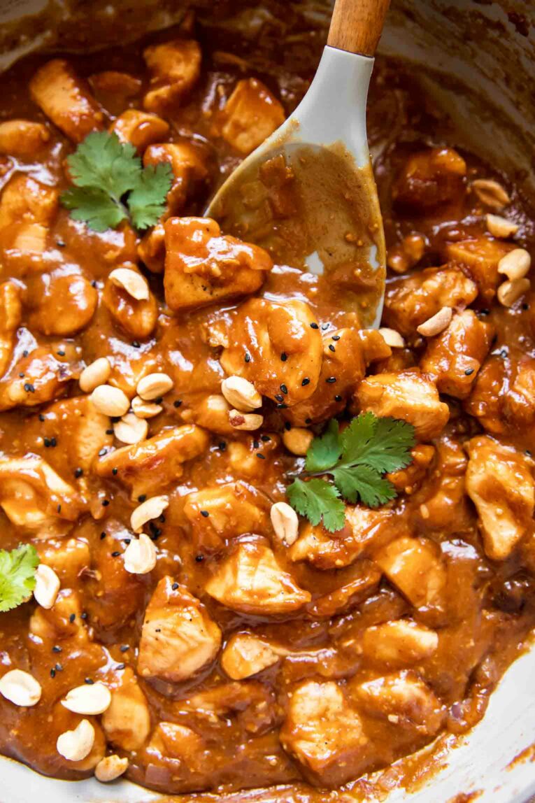 Peanut butter chicken being cooked in a large sauce pan.
