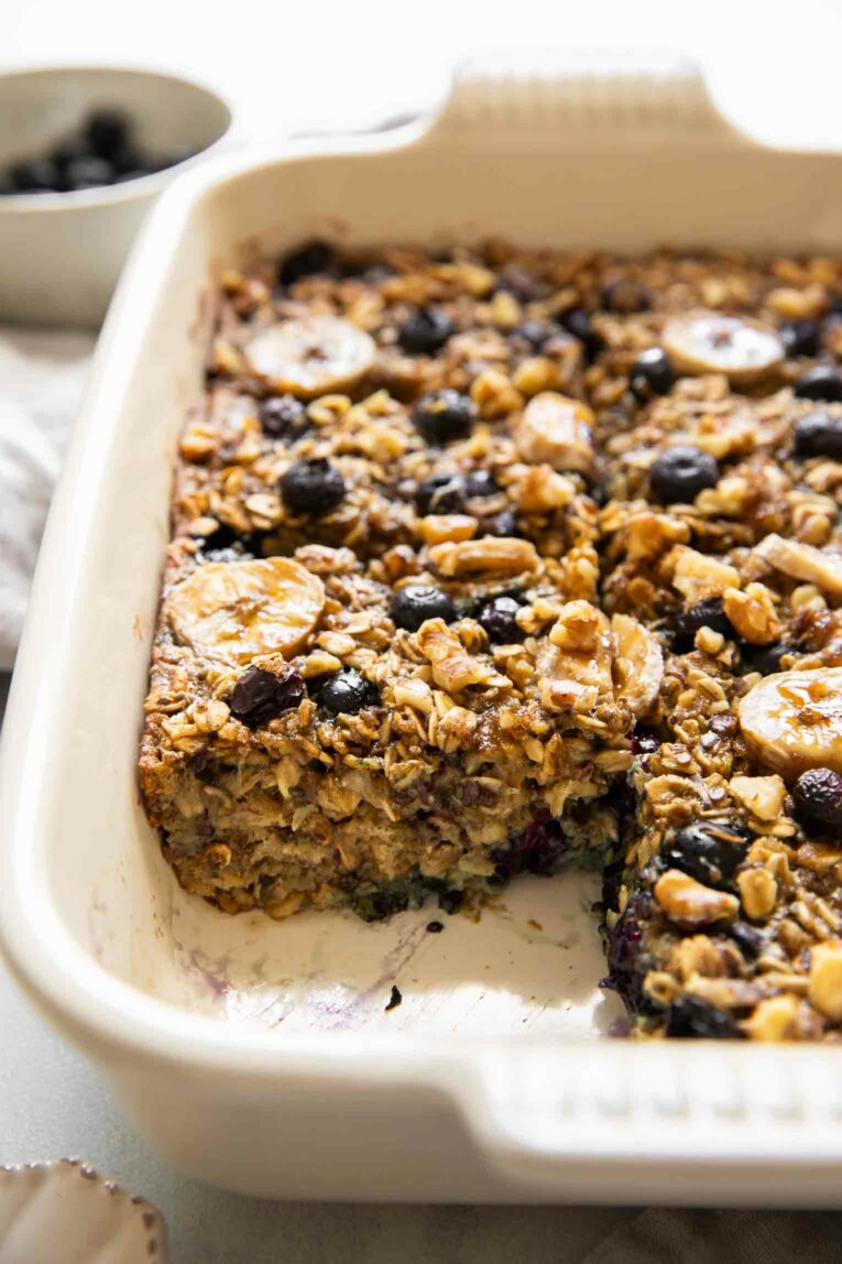 Across photo of blueberry banana baked oatmeal with slice taken out.
