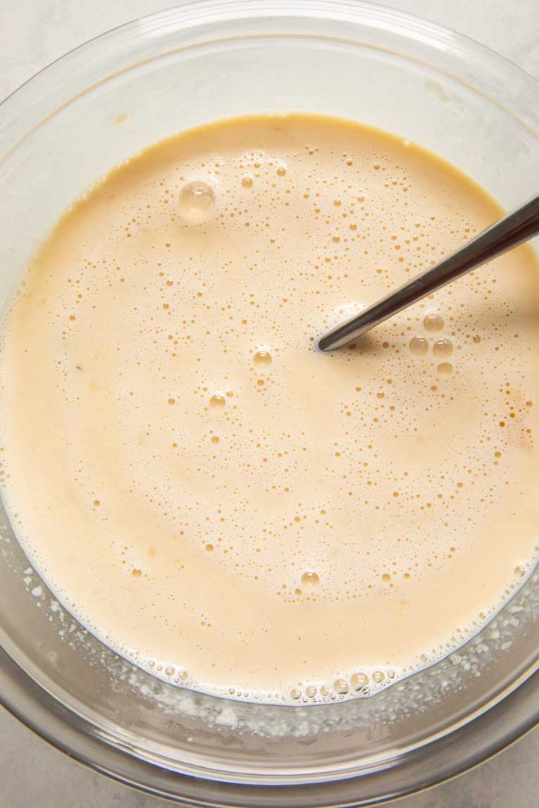 Liquid ingredients for banana baked oatmeal in a glass bowl.