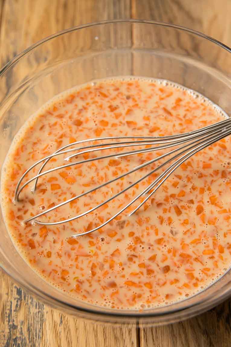 Liquid ingredients being whisked for carrot cake pancakes.
