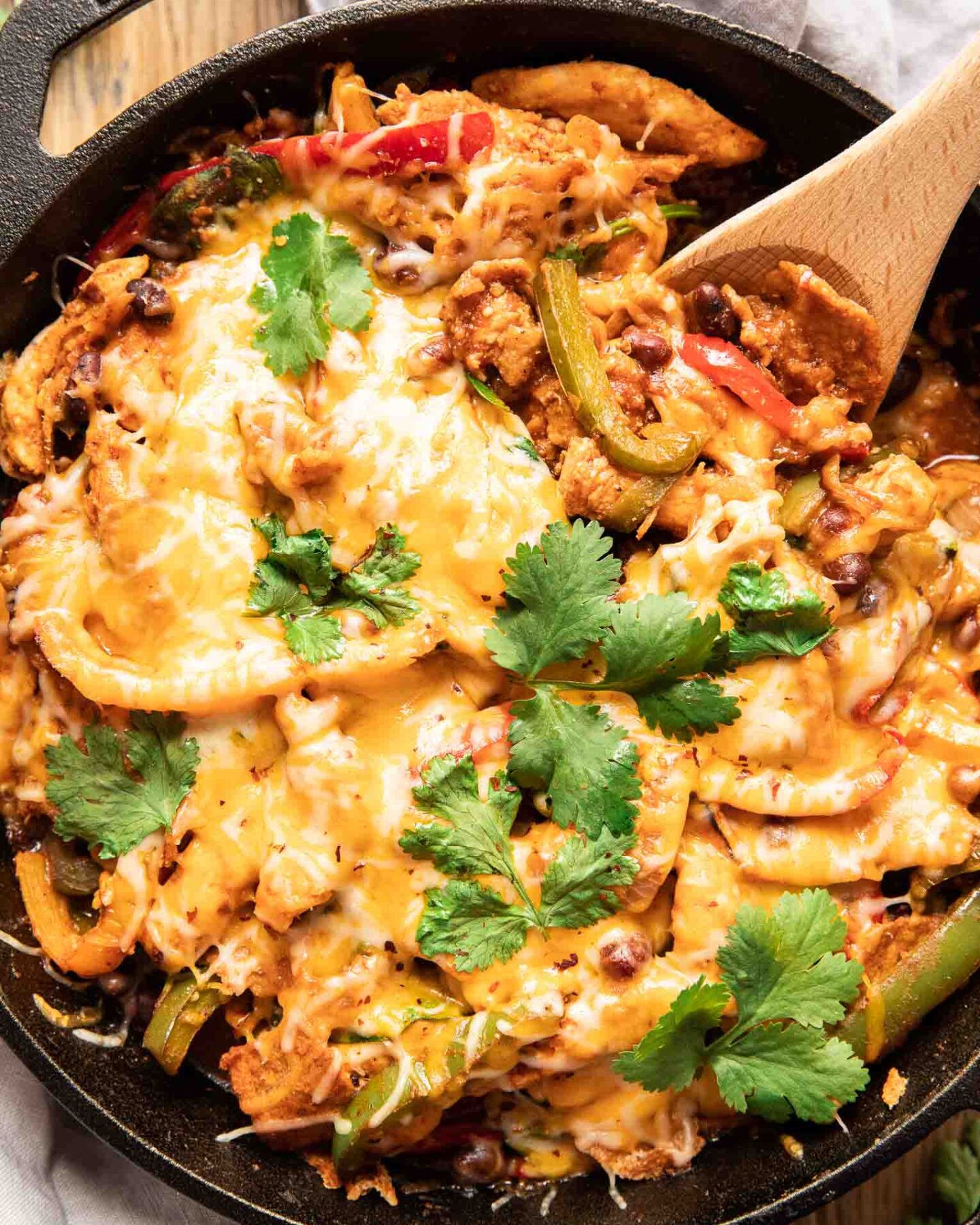 Top shot photo of chicken fajita casserole with a spoon.