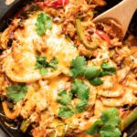 Top shot photo of chicken fajita casserole with a spoon.