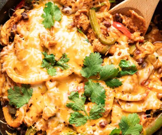 Top shot photo of chicken fajita casserole with a spoon.