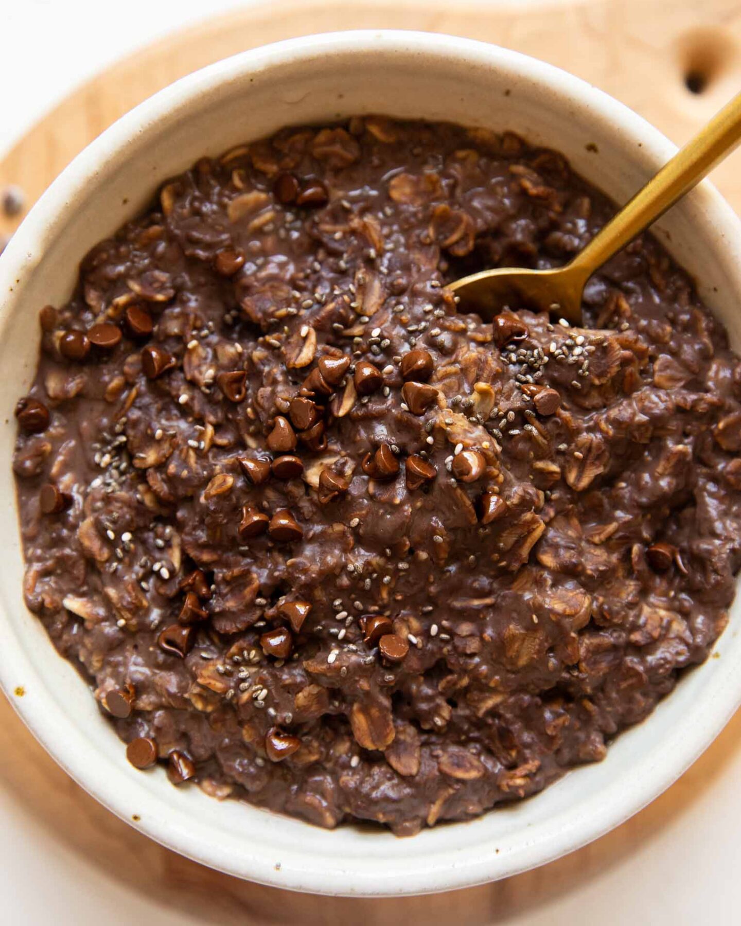 Top photo of Chocolate Protein Oats in a bowl with a spoon.