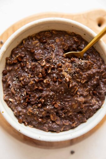 Top photo of Chocolate Protein Oats in a bowl with a spoon.