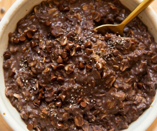 Top photo of Chocolate Protein Oats in a bowl with a spoon.