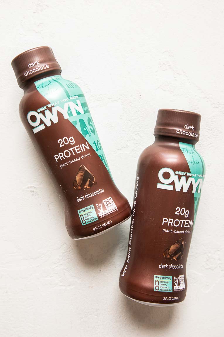 OWYN Dark Chocolate Protein Shakes on a white background.