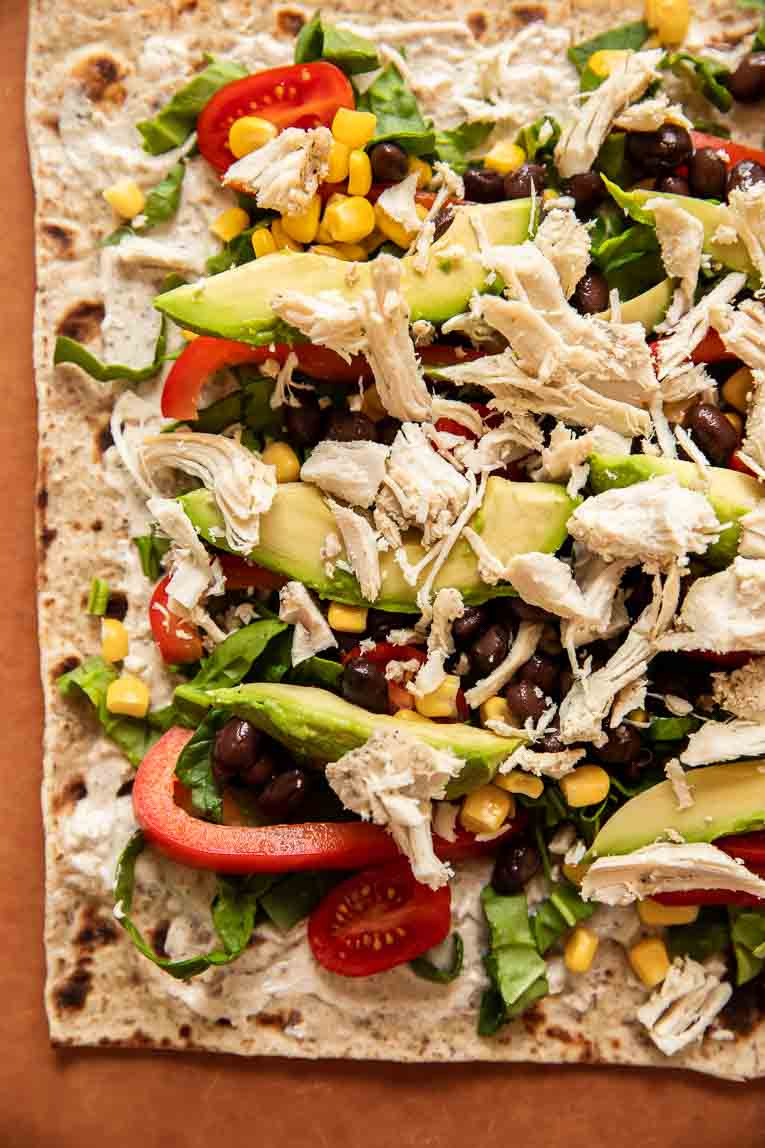 Toppings on ranch chicken wraps.