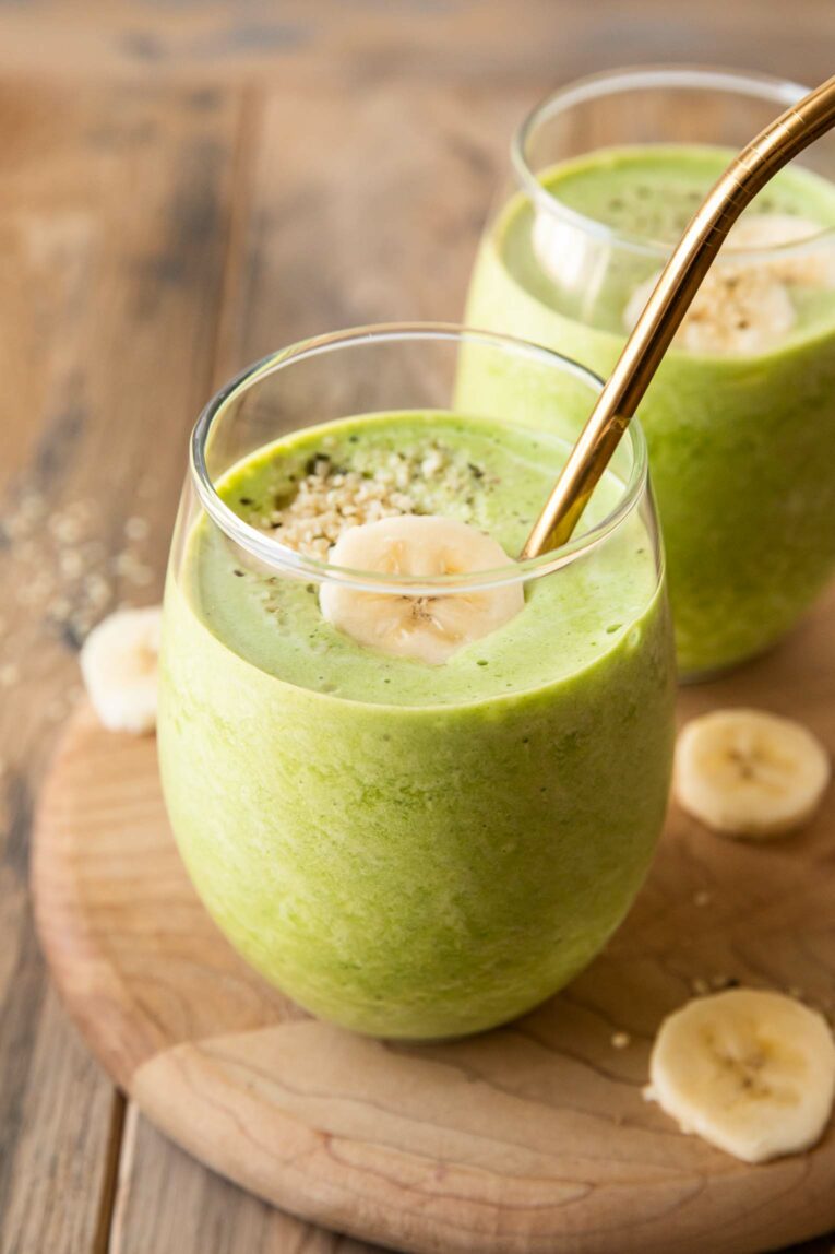 Angled photo of spinach banana smoothies.