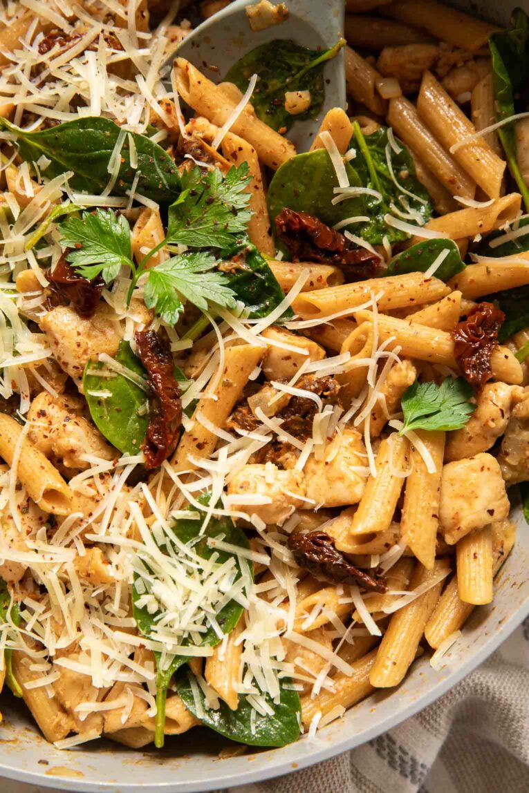 Top photo of one-pan sun dried tomato chicken pasta.