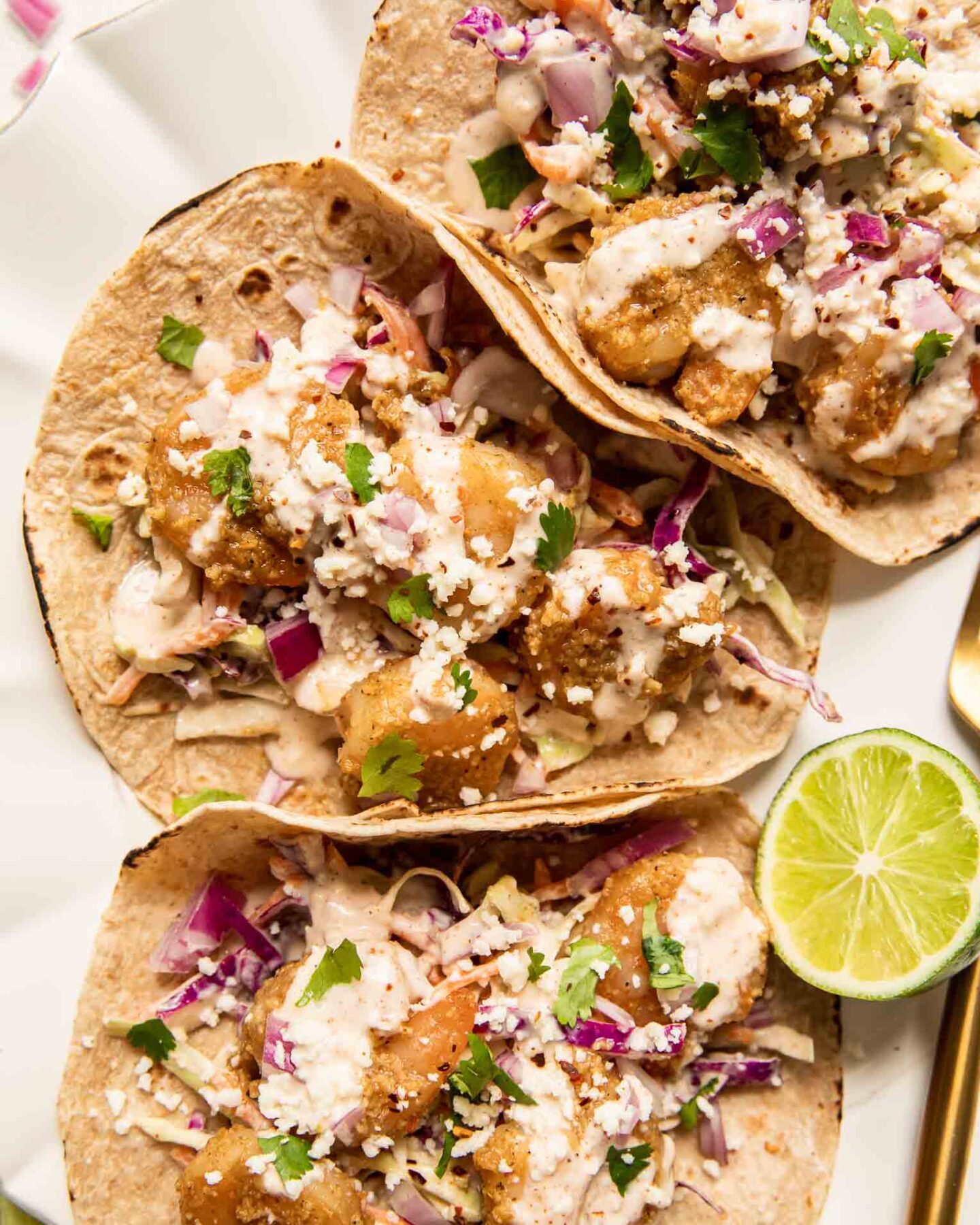 Baja Shrimp Tacos Recipe with limes on a plate.