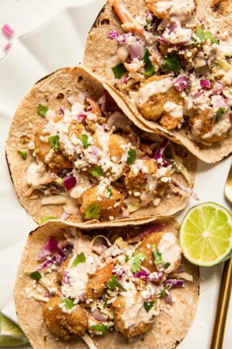 Baja Shrimp Tacos Recipe with limes on a plate.