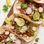 Vegan Chipotle Chickpea Tacos with lime and cilantro.