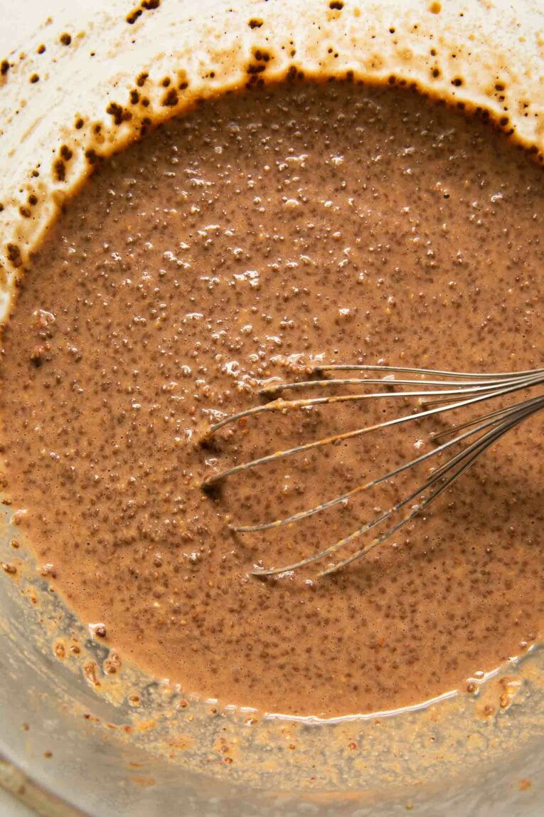 Chocolate chia pudding being mixed together in a bowl.