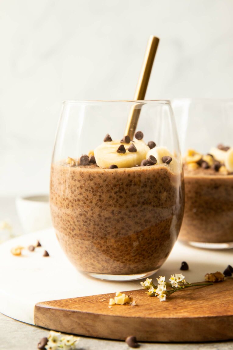 Chocolate Banana Chia Seed Pudding in a glass with banana and chocolate chips.
