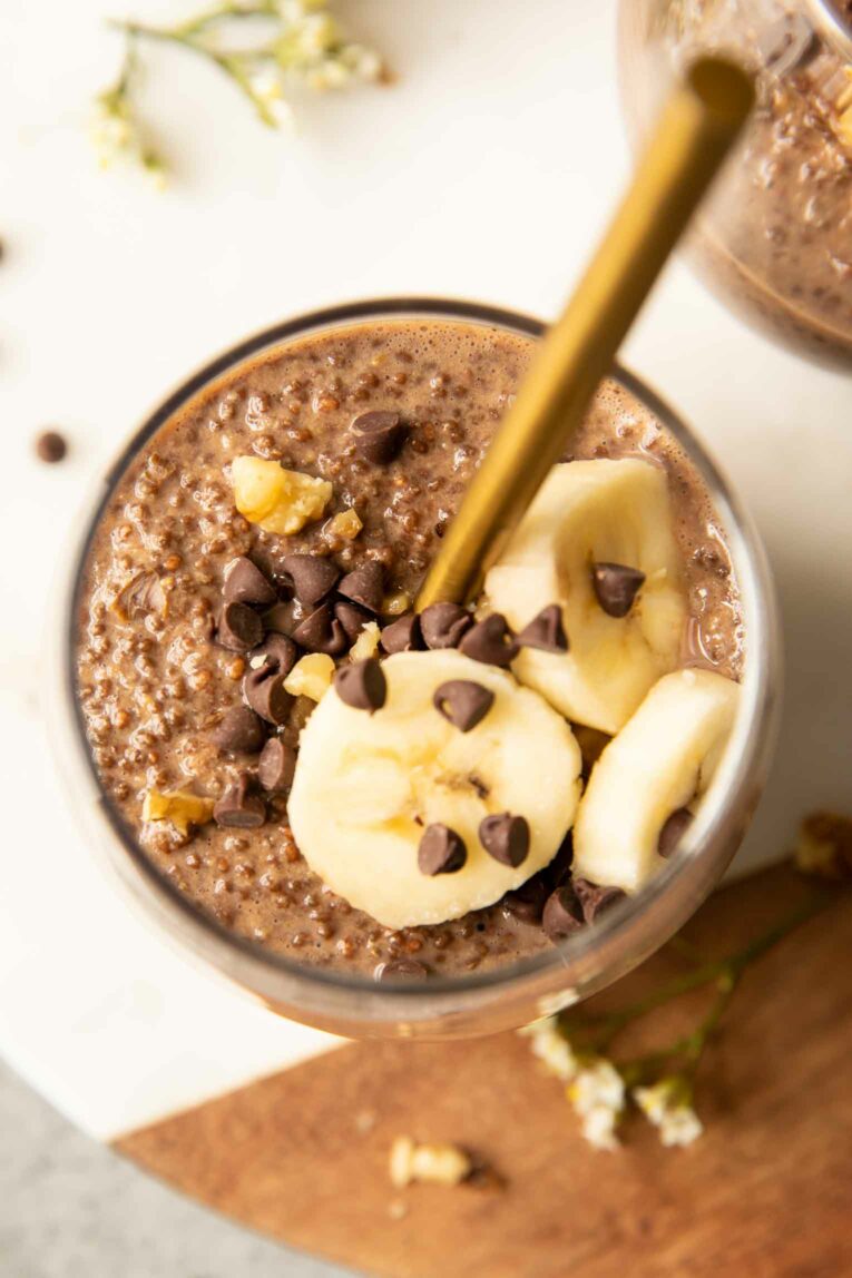 Top shot photo of Chocolate Banana Chia Seed Pudding with sliced bananas, walnuts, and chocolate chips.