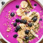 Dragon fruit smoothie bowl (pitaya smoothie bowl) with toppings.