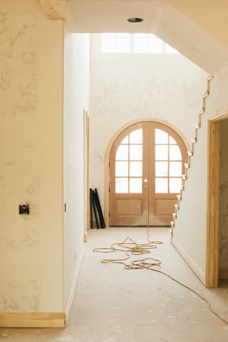 Arched from door in entryway with stairs.