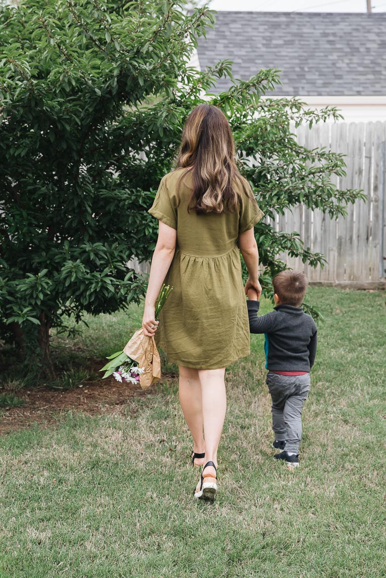 Mother walking with toddler.