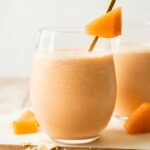 Cantaloupe Smoothie recipe in a glass with a straw.