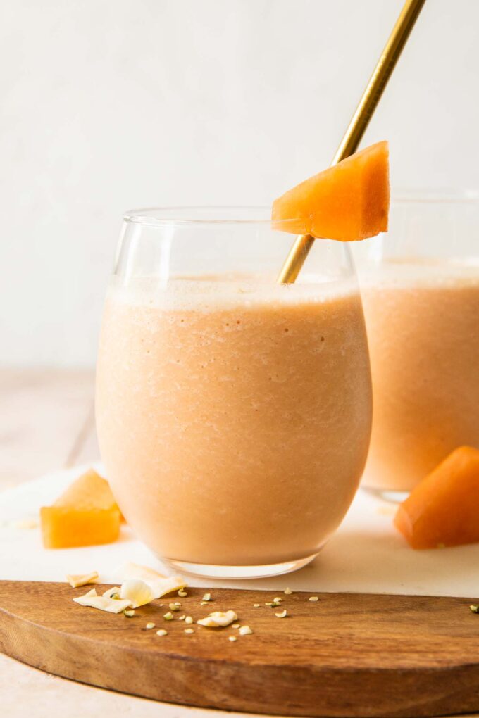 Cantaloupe Smoothie recipe in a glass with a straw.