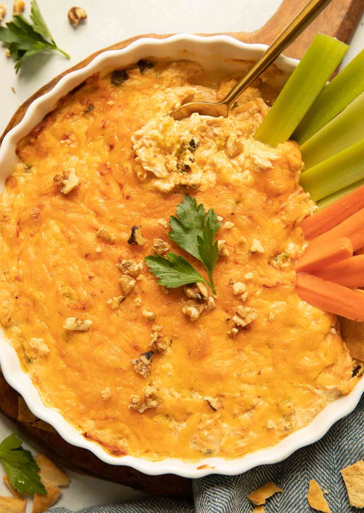 Healthy buffalo chicken dip recipe with celery, carrots, and parsley.