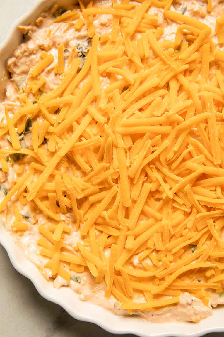 Buffalo chicken dip with shredded cheese.