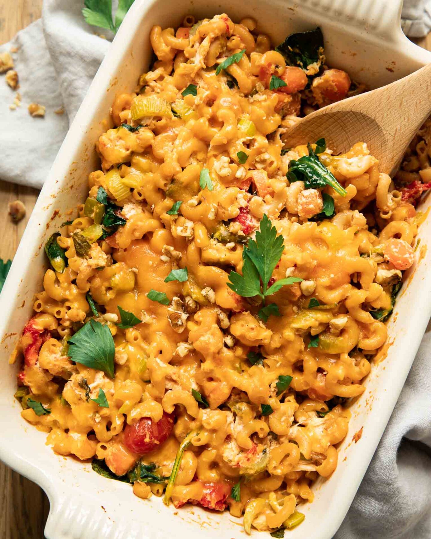Buffalo chicken pasta bake with a spoon in a casserole dish.
