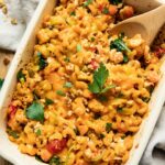 Buffalo chicken pasta bake with a spoon in a casserole dish.