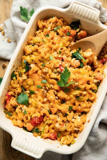 Buffalo chicken pasta bake with a spoon in a casserole dish.