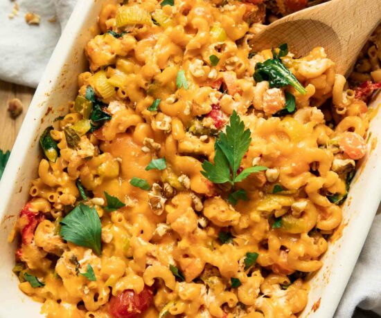 Buffalo chicken pasta bake with a spoon in a casserole dish.