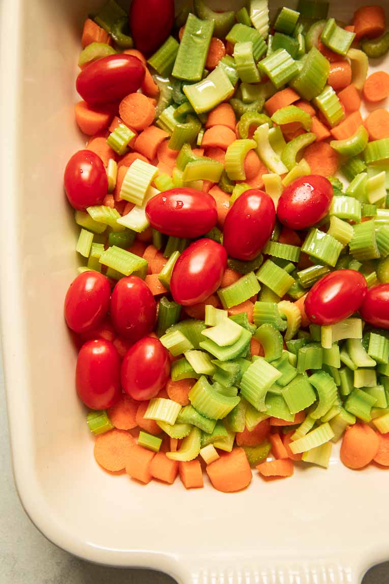 Vegetables roasting in a baking dish.