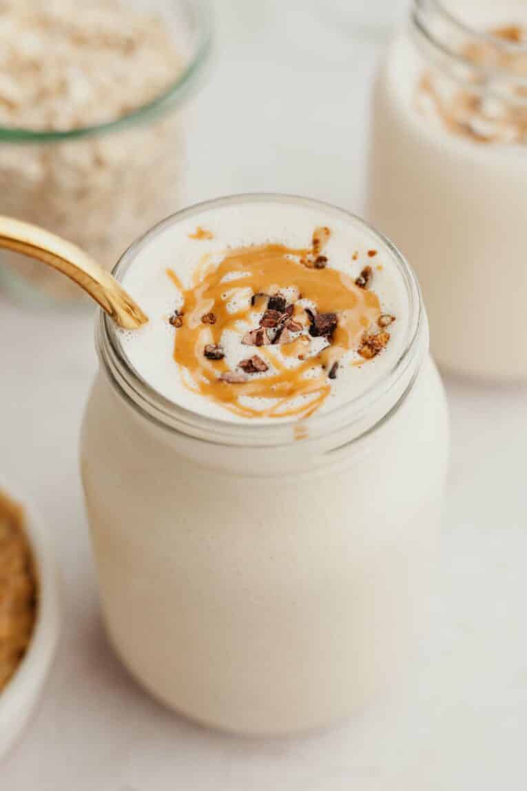 Angled photo of peanut butter smoothie in mason jar.
