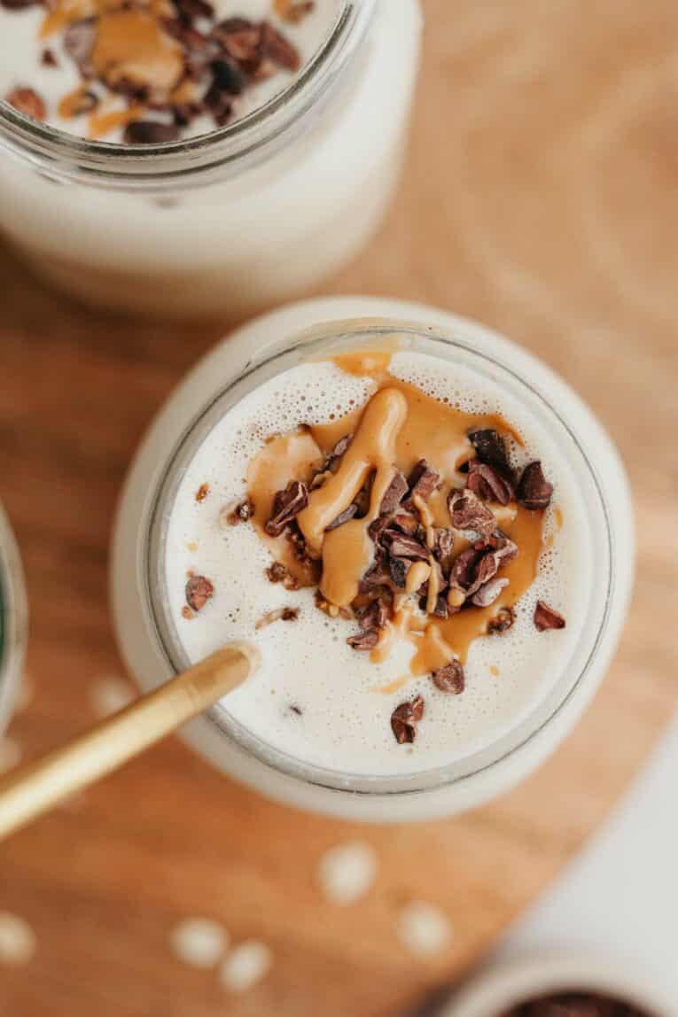 Top photo of peanut butter smoothie with toppings.