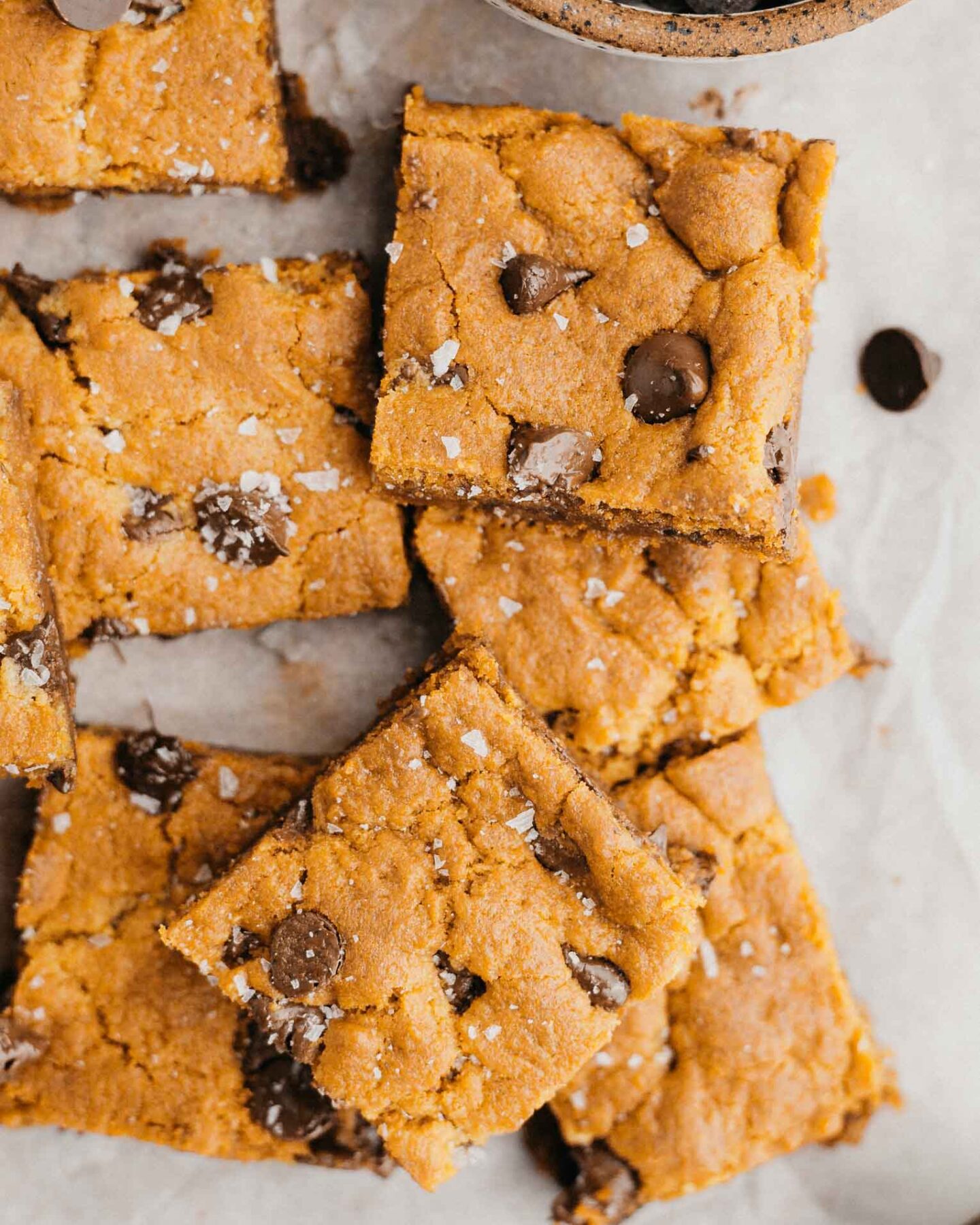 Vegan Chocolate Chip Cookie Bars on parchment paper.