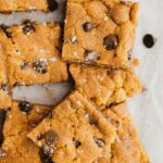 Vegan Chocolate Chip Cookie Bars on parchment paper.