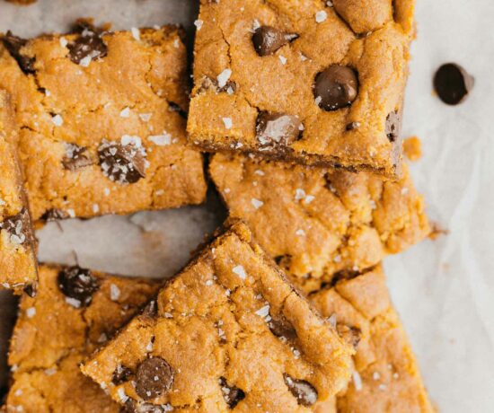 Vegan Chocolate Chip Cookie Bars on parchment paper.