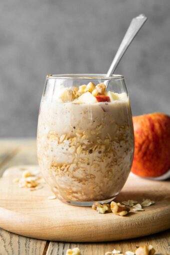 Apple Cinnamon Overnight Oats in a mason jar with a spoon.