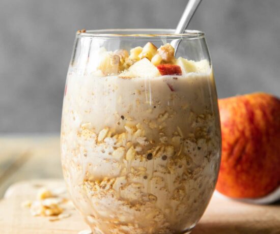 Apple Cinnamon Overnight Oats in a mason jar with a spoon.