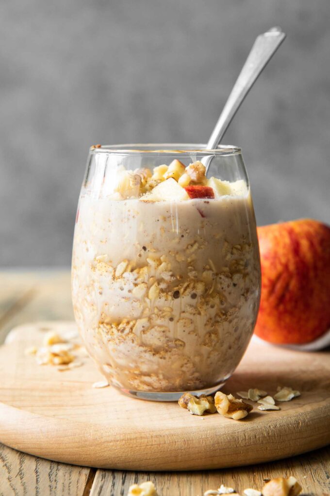 Apple Cinnamon Overnight Oats in a mason jar with a spoon.