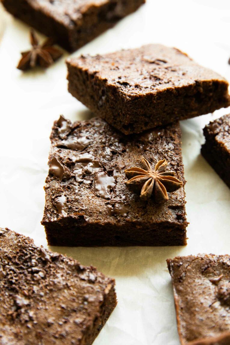 Angled photo of sweet potato brownies on parchment paper.