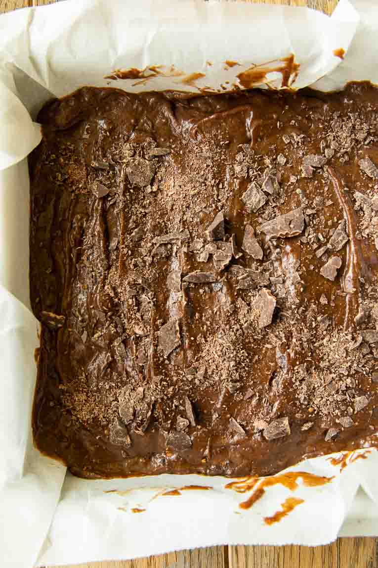 Brownie batter poured into a baking dish.