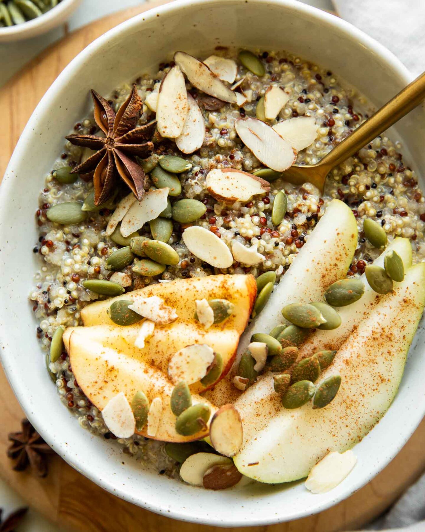 Quinoa breakfast bowl with fall spices and toppings.
