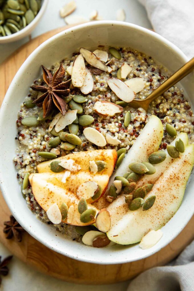 Quinoa breakfast bowl with fall spices and toppings.