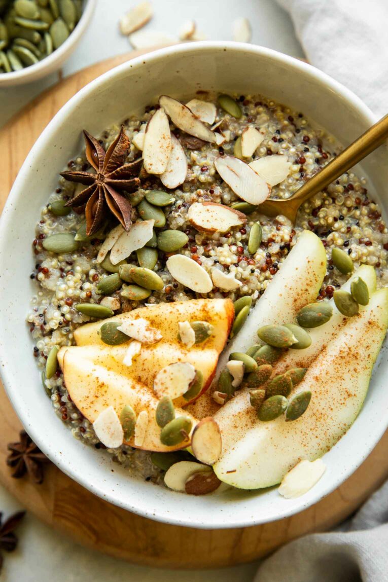 Quinoa breakfast bowl with fall spices and toppings.