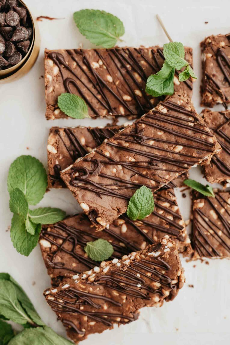 Mint chocolate protein bars with fresh mint and chocolate chips.