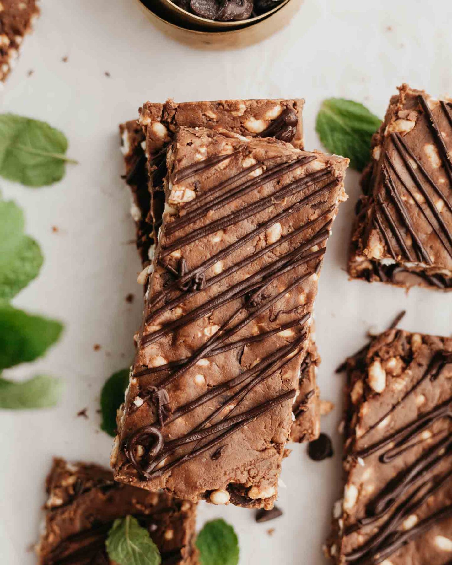 Mint dark chocolate protein bars with mint and chocolate chips on a white background.