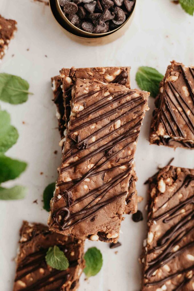 Mint dark chocolate protein bars with mint and chocolate chips on a white background.