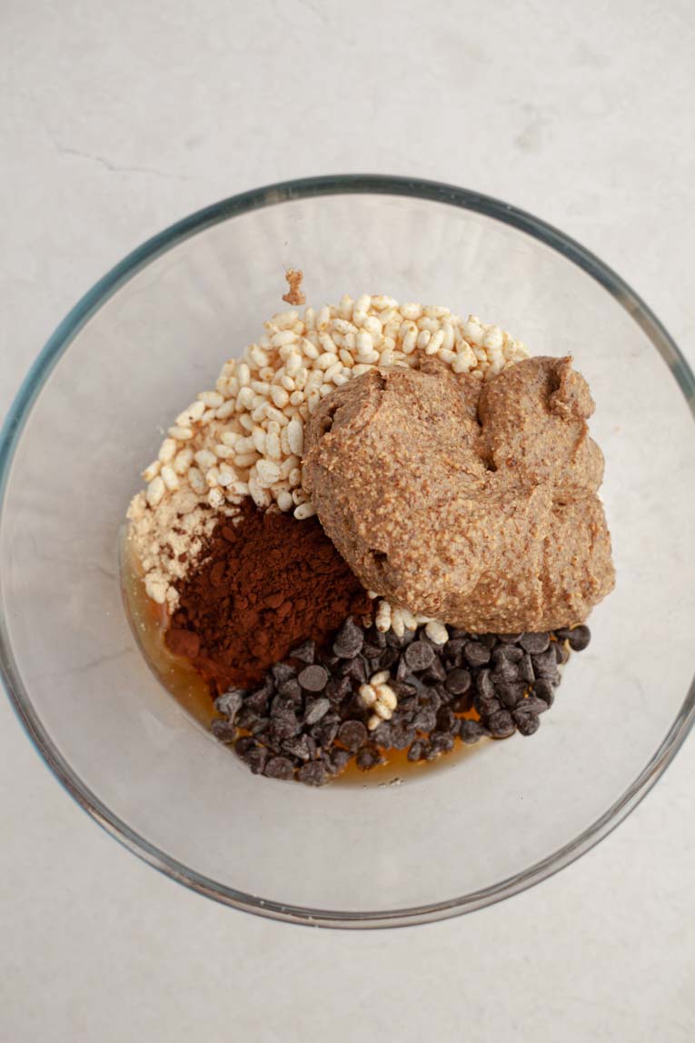 Ingredients for protein bars in a mixing bowl.