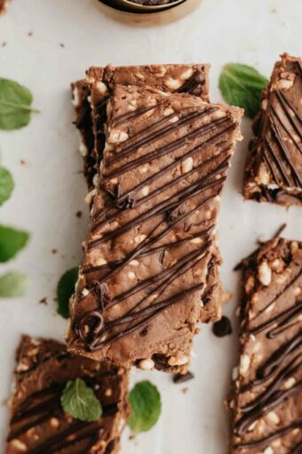 Mint dark chocolate protein bars with mint and chocolate chips on a white background.